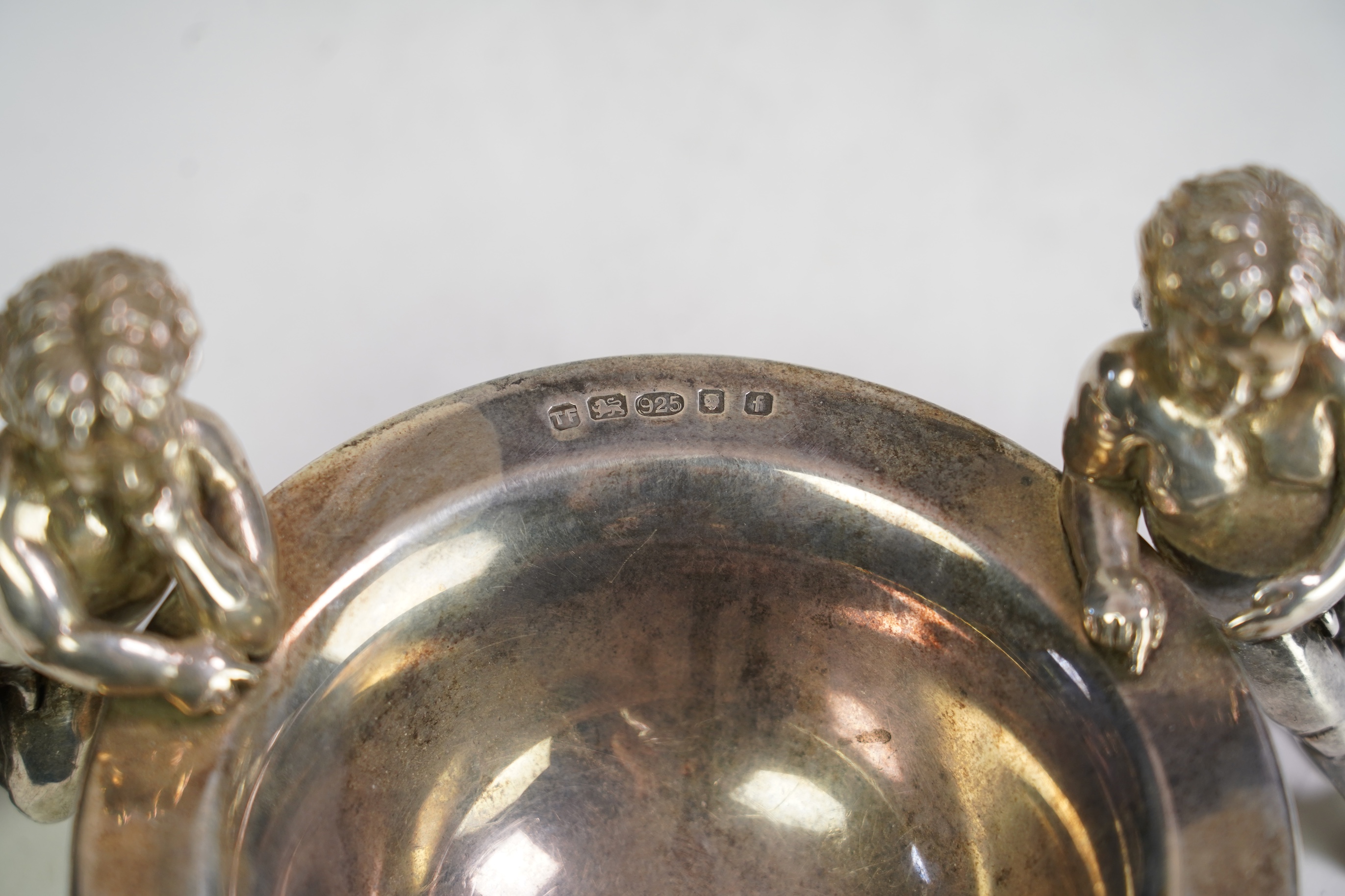 An Elizabeth II Theo Fennell silver bonbon bowl, with three cherub supports